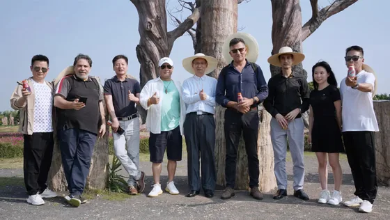 Delegation members gather in the silicified-wood park at Senshan Health Town.