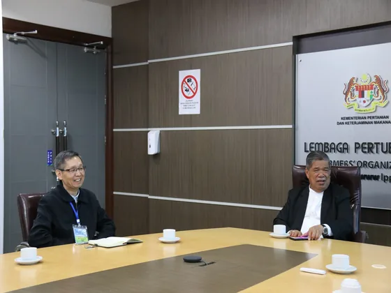 Representatives speak across the table during the agricultural-cooperation meeting.