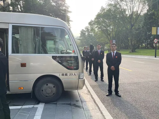 Operational personnel beside a delegation vehicle during the forum programme.