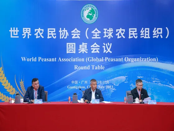 Roundtable participants beneath the November 2023 event backdrop.