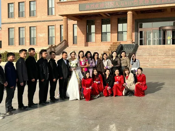 A group photograph outside a venue during the Xinjiang visit.