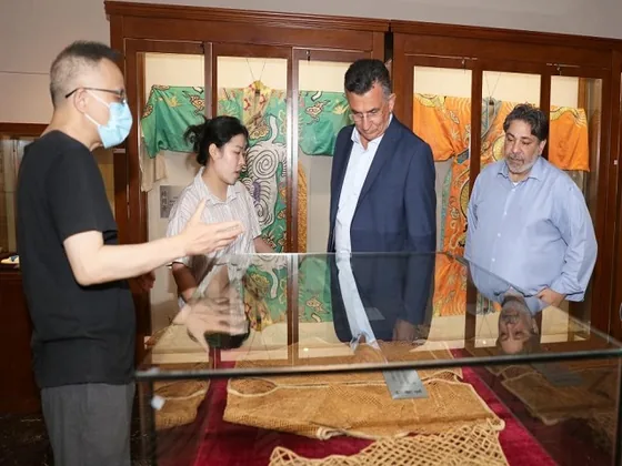 The delegation views exhibits and traditional costumes in the Wu Opera Museum.