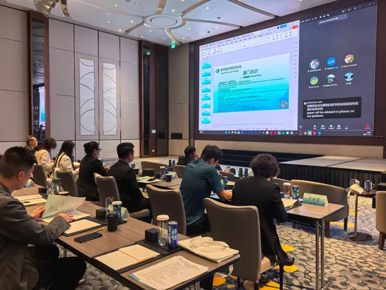A second published view of the Macao audience and presentation screen.