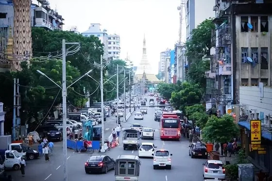 An urban avenue leading toward a pagoda in Myanmar; contextual image accompanying the report.