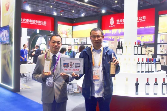 Visitors presenting bottled products at the exhibition stand.