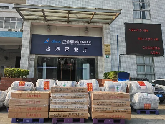Tents, blankets and boxed relief supplies await departure outside the airport logistics office.