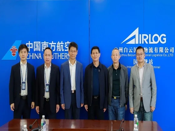 A group photograph with China Southern Airlines and airport logistics signage.
