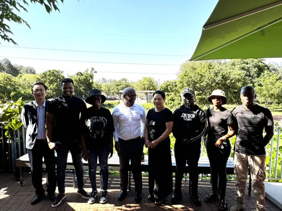 Participants and students gather outdoors during the South African scholarship awards.